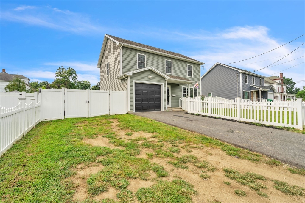 25 Thomas Street Chicopee, MA 01013 - Photo 2 of 36 a front view of a house with a yard and garage