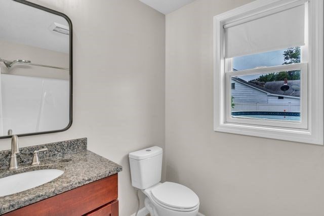 25 Thomas Street Chicopee, MA 01013 - Photo 22 of 36 a bathroom with a granite countertop sink mirror vanity and toilet