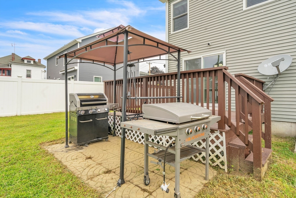 25 Thomas Street Chicopee, MA 01013 - Photo 32 of 36 a view of a patio with a table and chairs under an umbrella
