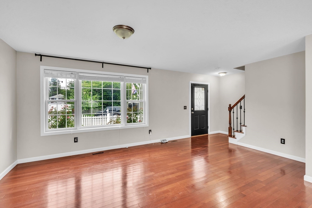 25 Thomas Street Chicopee, MA 01013 - Photo 5 of 36 a view of an empty room with wooden floor and a window
