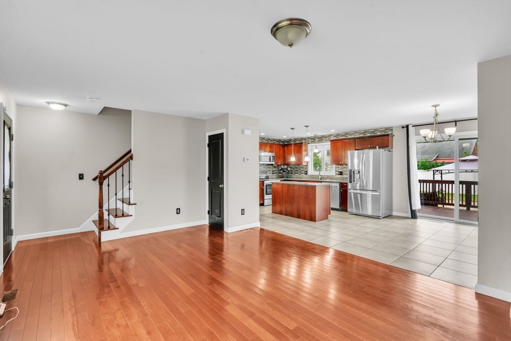 25 Thomas Street Chicopee, MA 01013 - Photo 7 of 36 a view of an empty room with wooden floor and windows