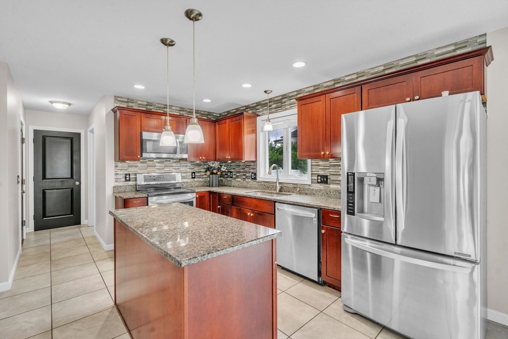 25 Thomas Street Chicopee, MA 01013 - Photo 10 of 36 a kitchen with stainless steel appliances granite countertop a refrigerator and a stove top oven