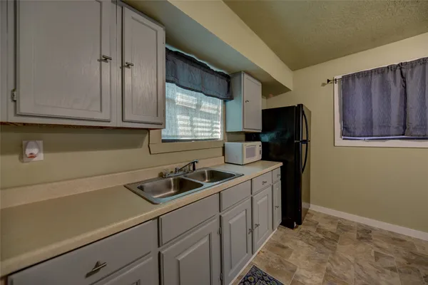 a kitchen with stainless steel appliances a refrigerator sink and cabinets