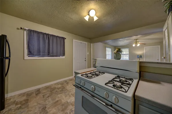 a kitchen with a stove and a refrigerator