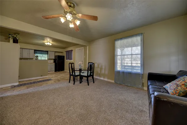a view of a livingroom with furniture and a ceiling fan