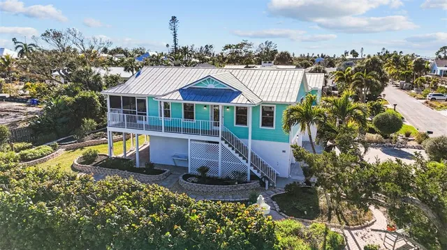 a view of a house with a garden and swimming pool