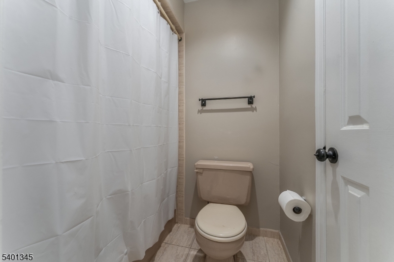 2103 Jamestown Common Hillsborough, NJ 08844 - Photo 15 of 18 a white toilet sitting next to a shower