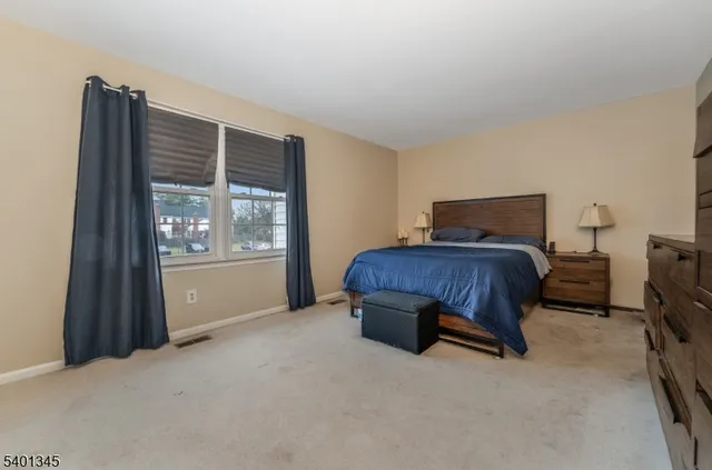 a living room with furniture a flat screen tv and windows