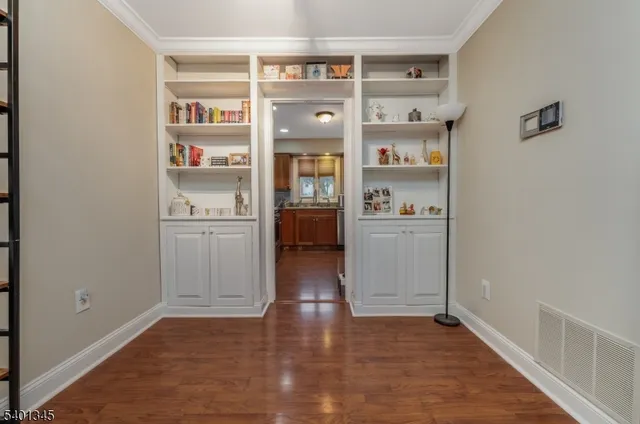 a kitchen with stainless steel appliances a refrigerator and wooden floor