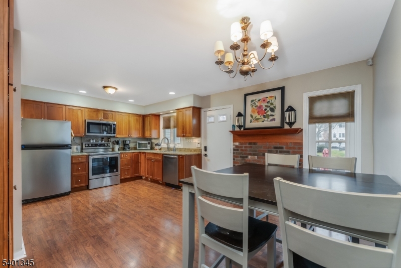 2103 Jamestown Common Hillsborough, NJ 08844 - Photo 7 of 18 a living room with fireplace furniture and a kitchen view