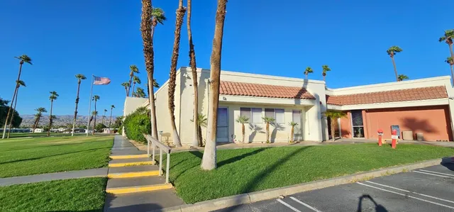 a view of a building with a yard