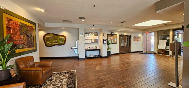 a view of a livingroom with furniture staircase and a workspace