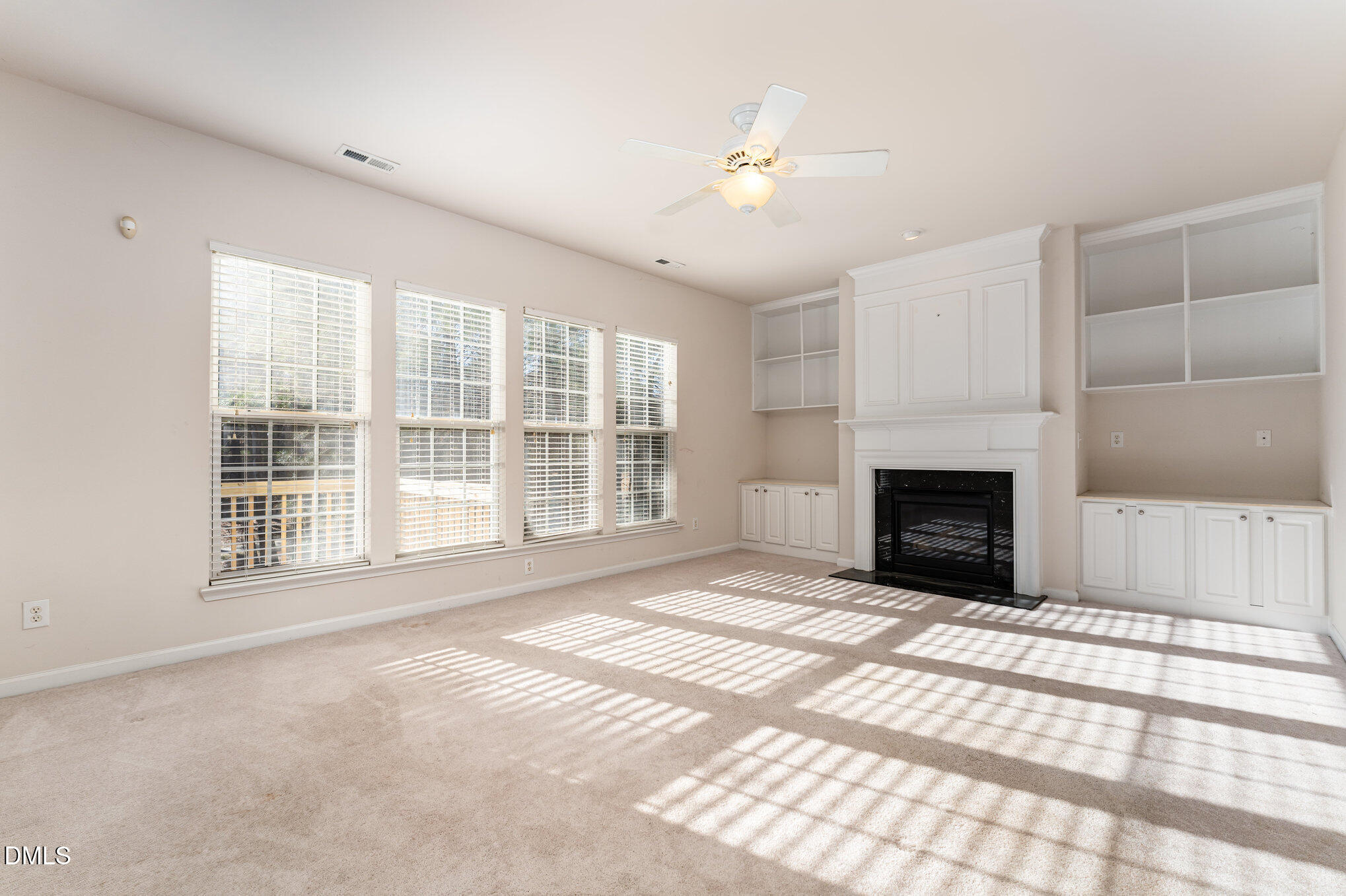 12347 Honeychurch Street Raleigh, NC 27614 - Photo 15 of 62 a view of an empty room with a fireplace and a window
