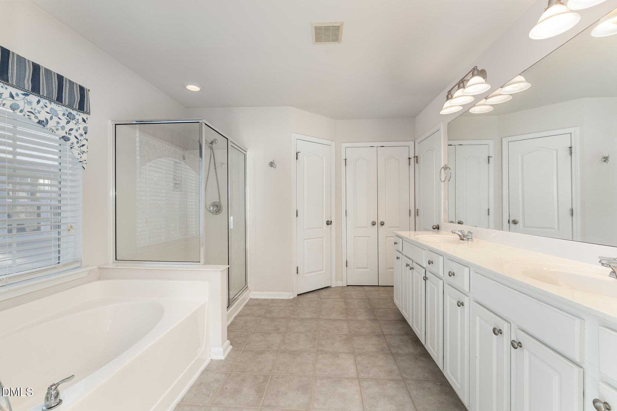 12347 Honeychurch Street Raleigh, NC 27614 - Photo 23 of 62 a bathroom with a tub a sink and a shower