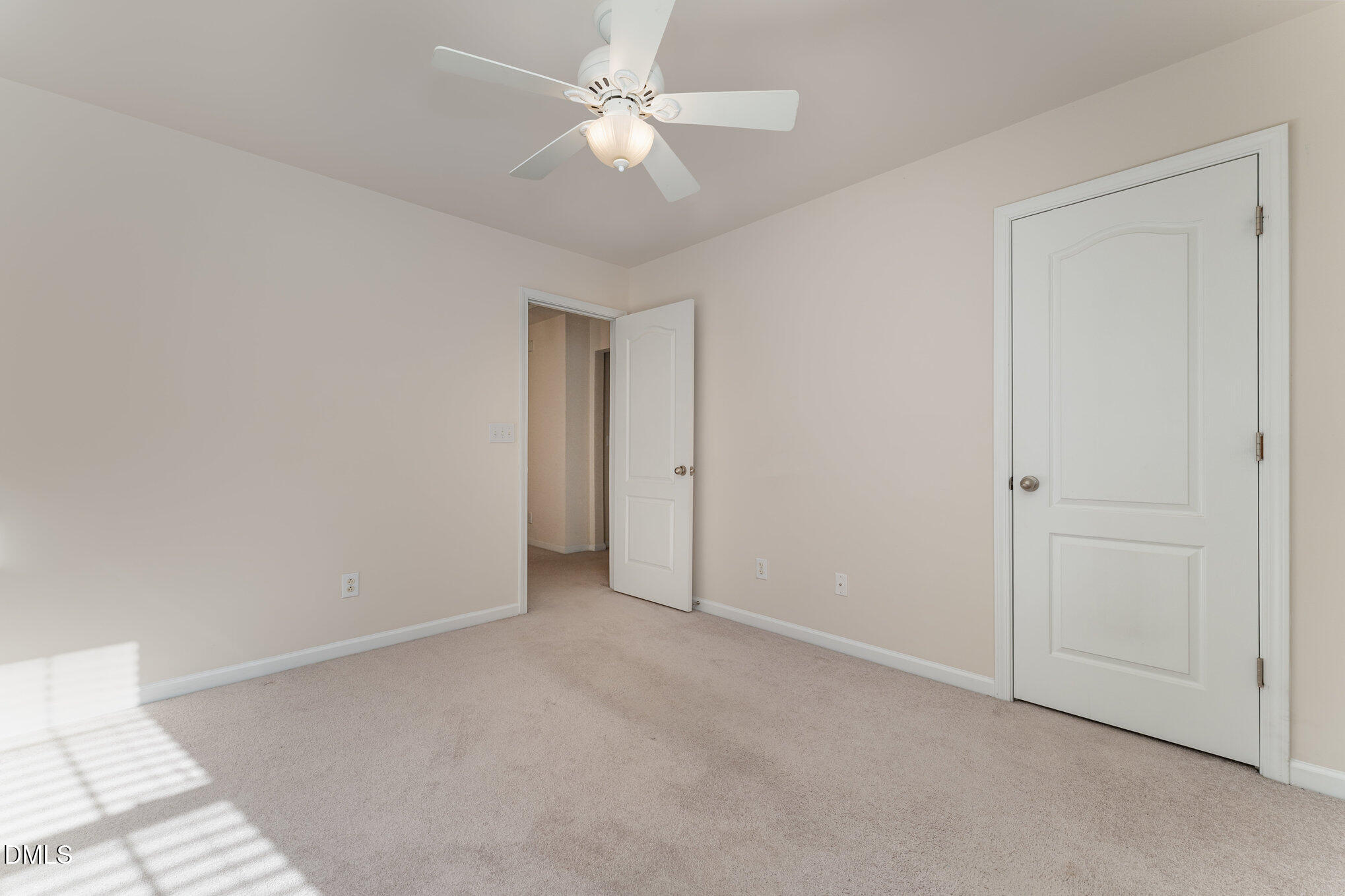 12347 Honeychurch Street Raleigh, NC 27614 - Photo 34 of 62 an empty room with a ceiling fan and a window