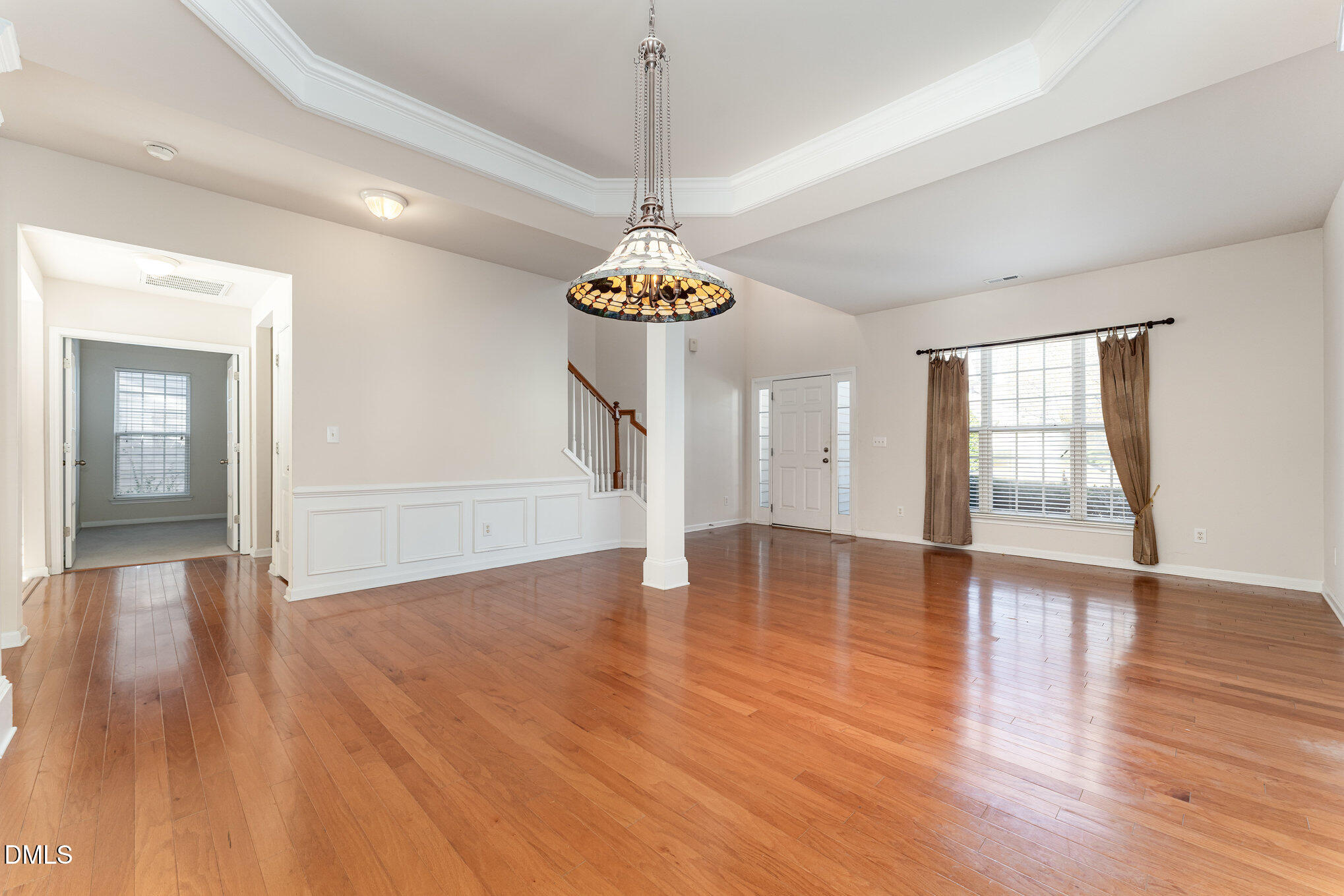 12347 Honeychurch Street Raleigh, NC 27614 - Photo 7 of 62 a view of an empty room with wooden floor and a window
