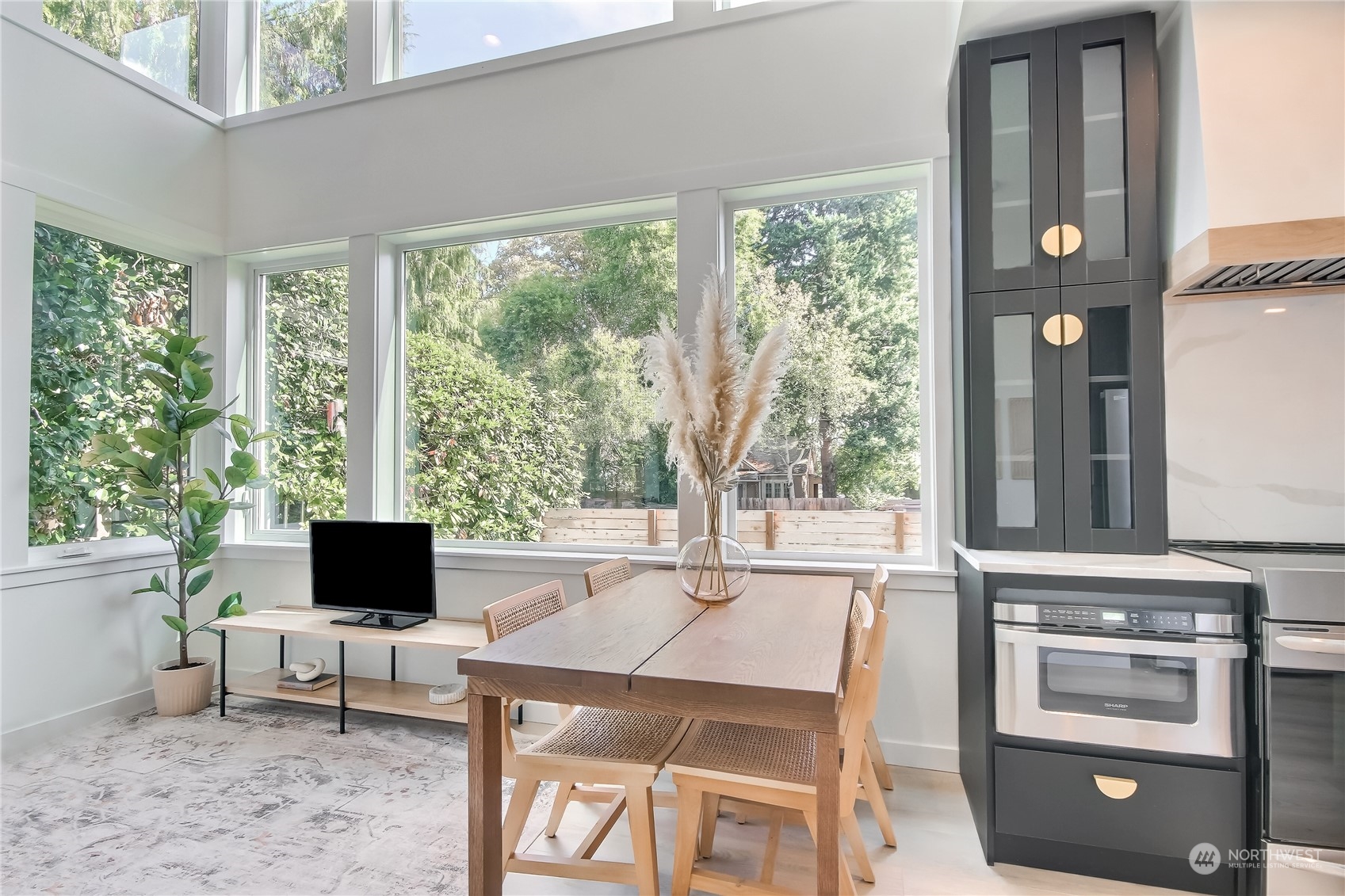 6839 35th Avenue Northeast, Unit A Seattle, WA 98115 - Photo 12 of 39 a living room with furniture a flat screen tv and a floor to ceiling window
