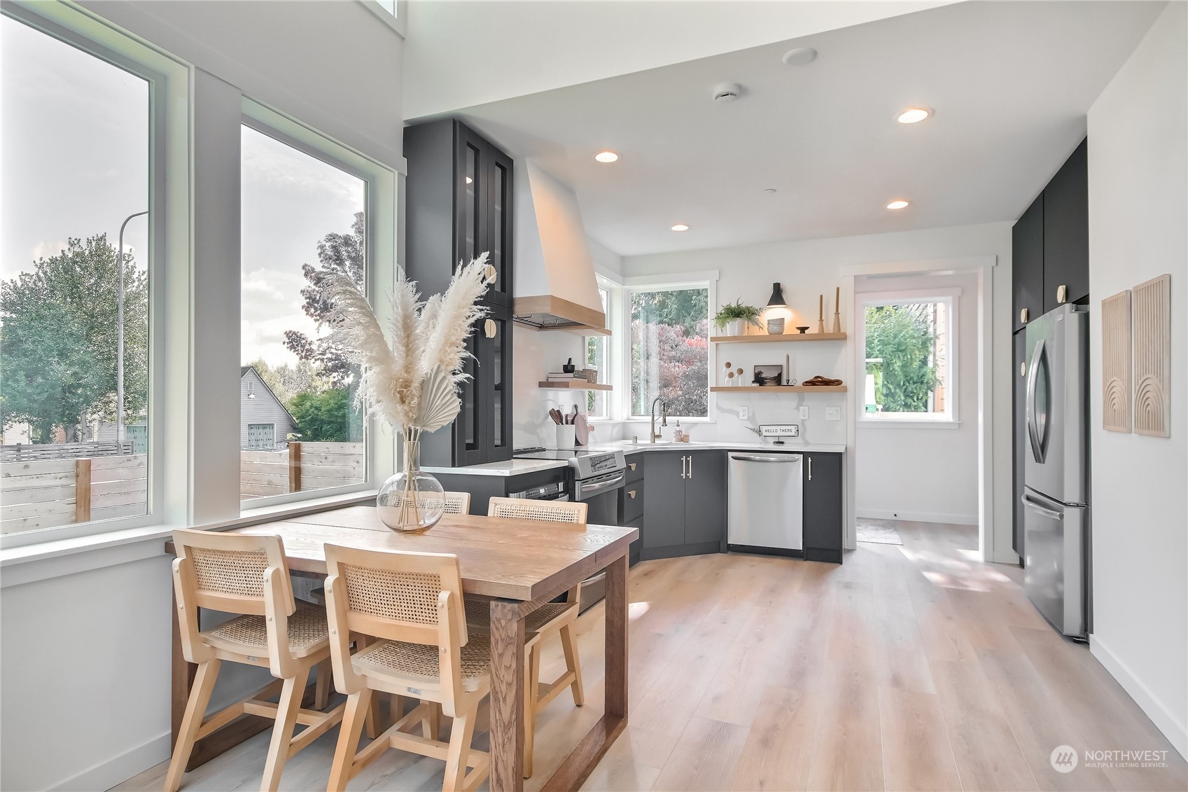 6839 35th Avenue Northeast, Unit A Seattle, WA 98115 - Photo 14 of 39 a kitchen with a table chairs refrigerator and microwave