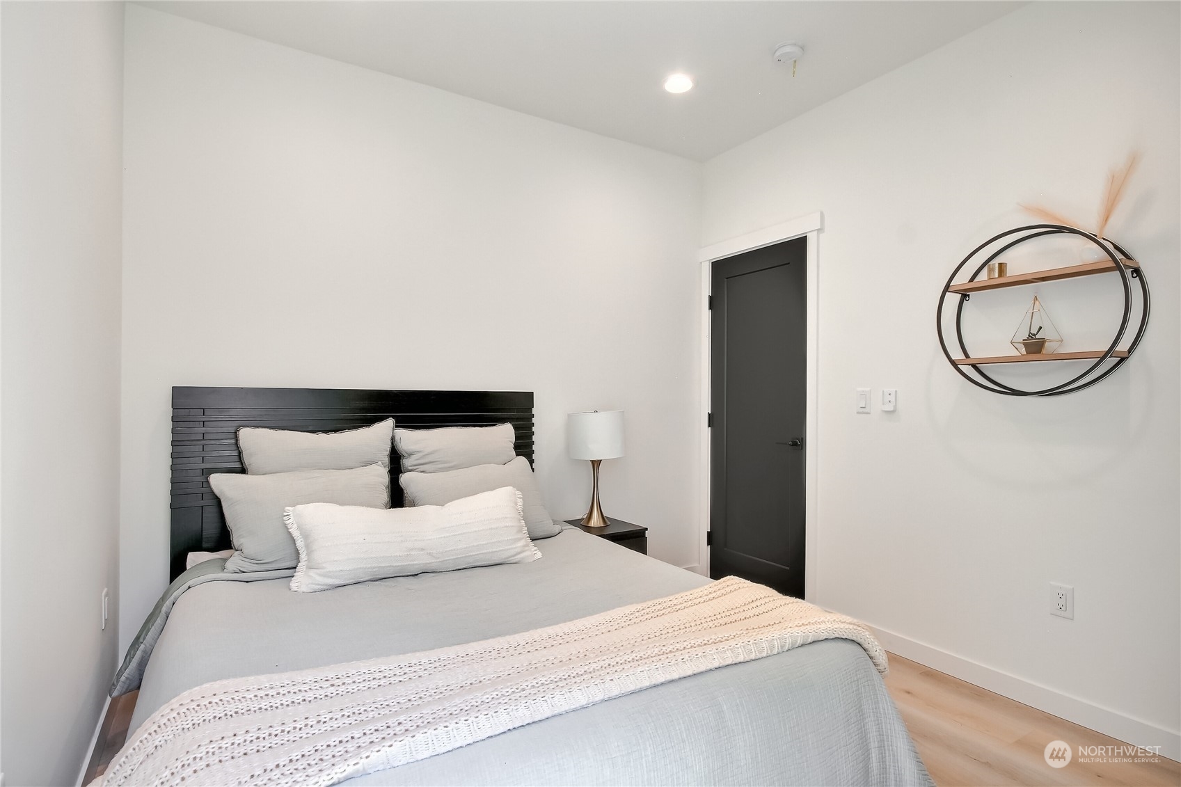 6839 35th Avenue Northeast, Unit A Seattle, WA 98115 - Photo 19 of 39 a bedroom with a bed and a wall painting