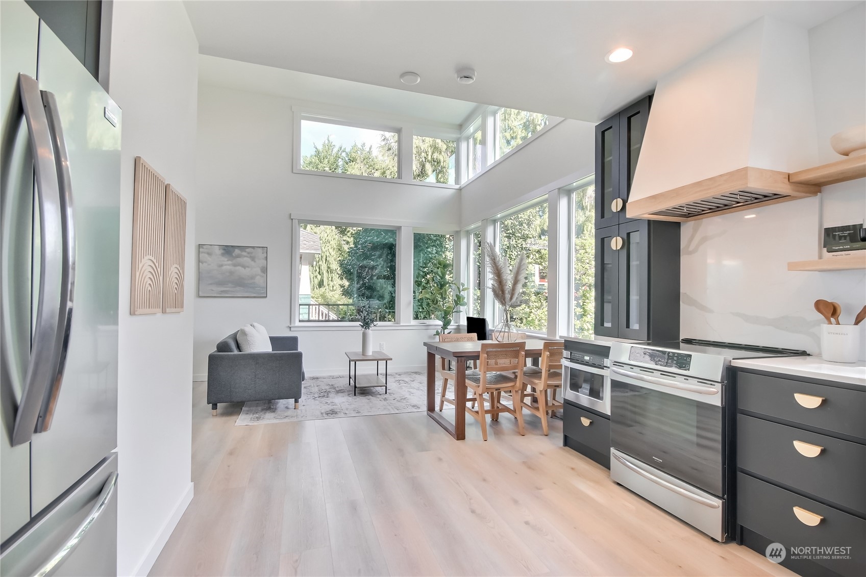 6839 35th Avenue Northeast, Unit A Seattle, WA 98115 - Photo 5 of 39 a living room with furniture a large window wooden floor and stainless steel appliances