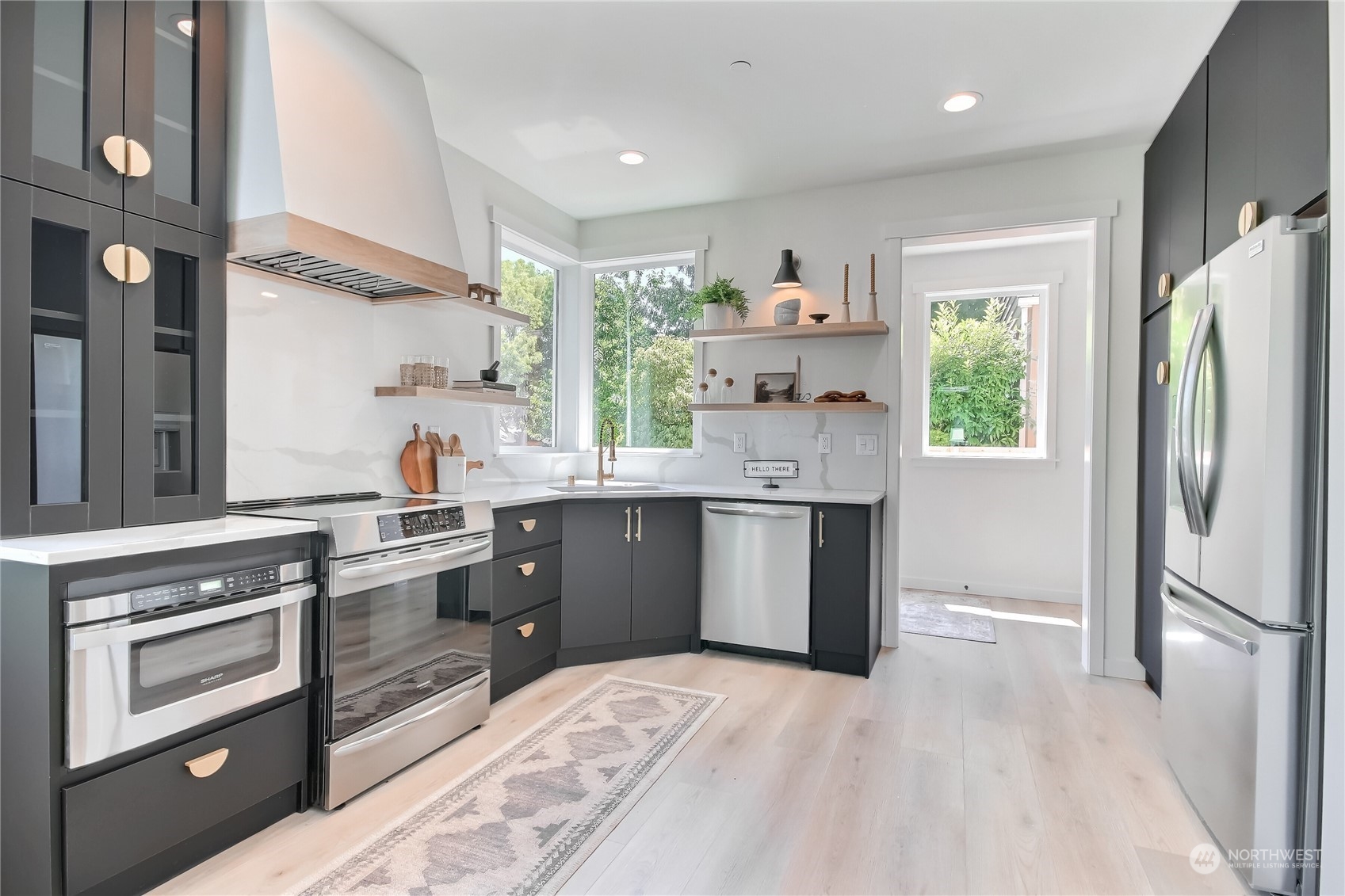 6839 35th Avenue Northeast, Unit A Seattle, WA 98115 - Photo 6 of 39 a kitchen with stainless steel appliances granite countertop a refrigerator sink and stove