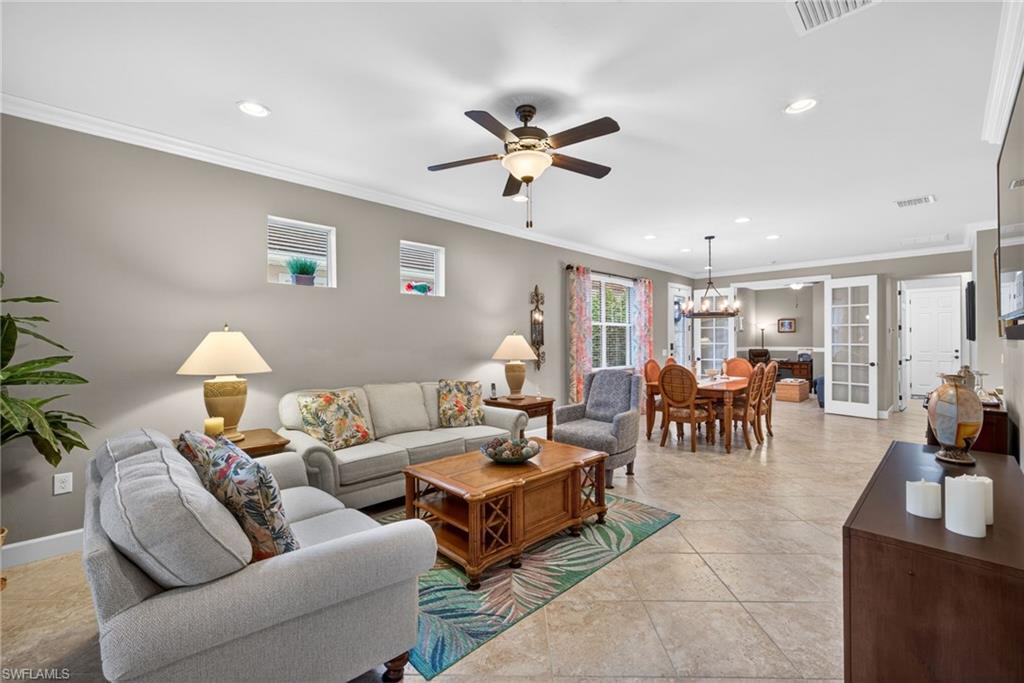 20105 Torch Key Way Estero, FL 33928 - Photo 7 of 29 a living room with furniture and a chandelier