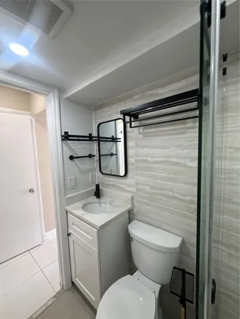 a bathroom with a toilet sink and shower