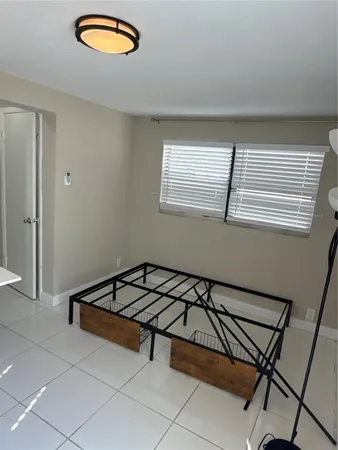a kitchen with a refrigerator sink and cabinets