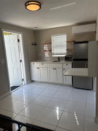 a kitchen with stainless steel appliances a sink and cabinets