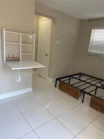 a room with washing machine and cabinets