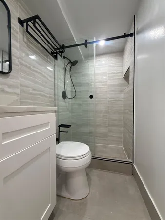 a bathroom with a toilet and shower