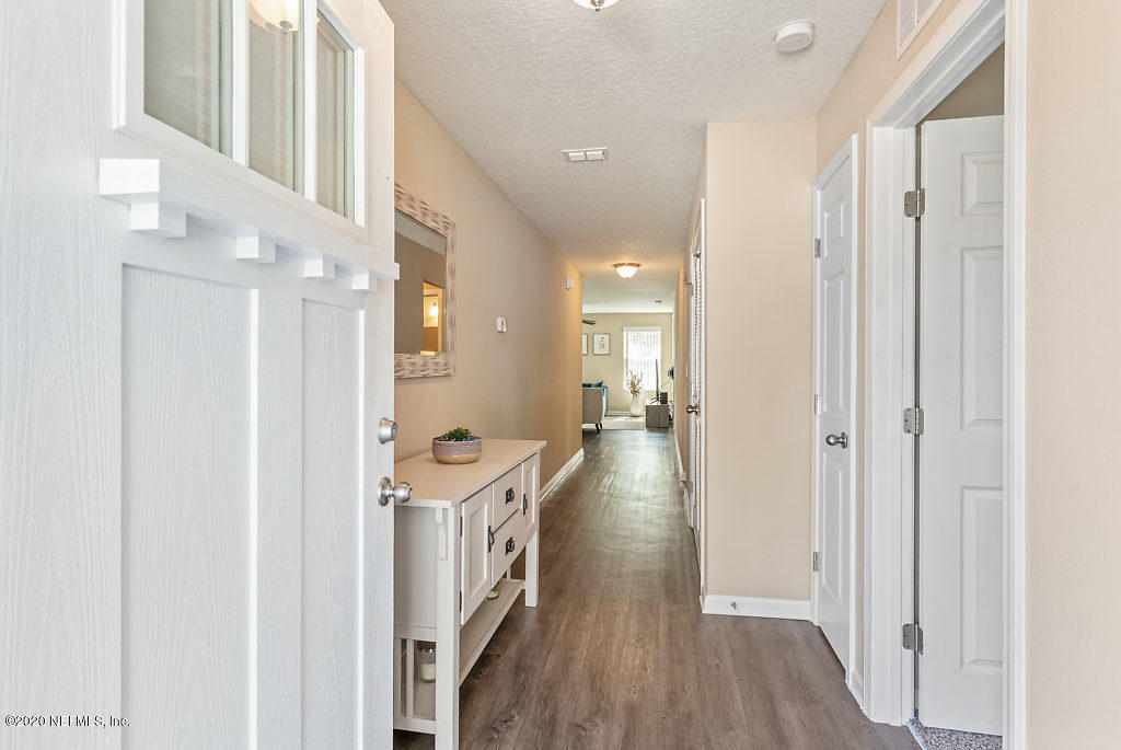 6225 Suwanee Road Jacksonville, FL 32217 - Photo 8 of 34 a view of a hallway with wooden floor and staircase