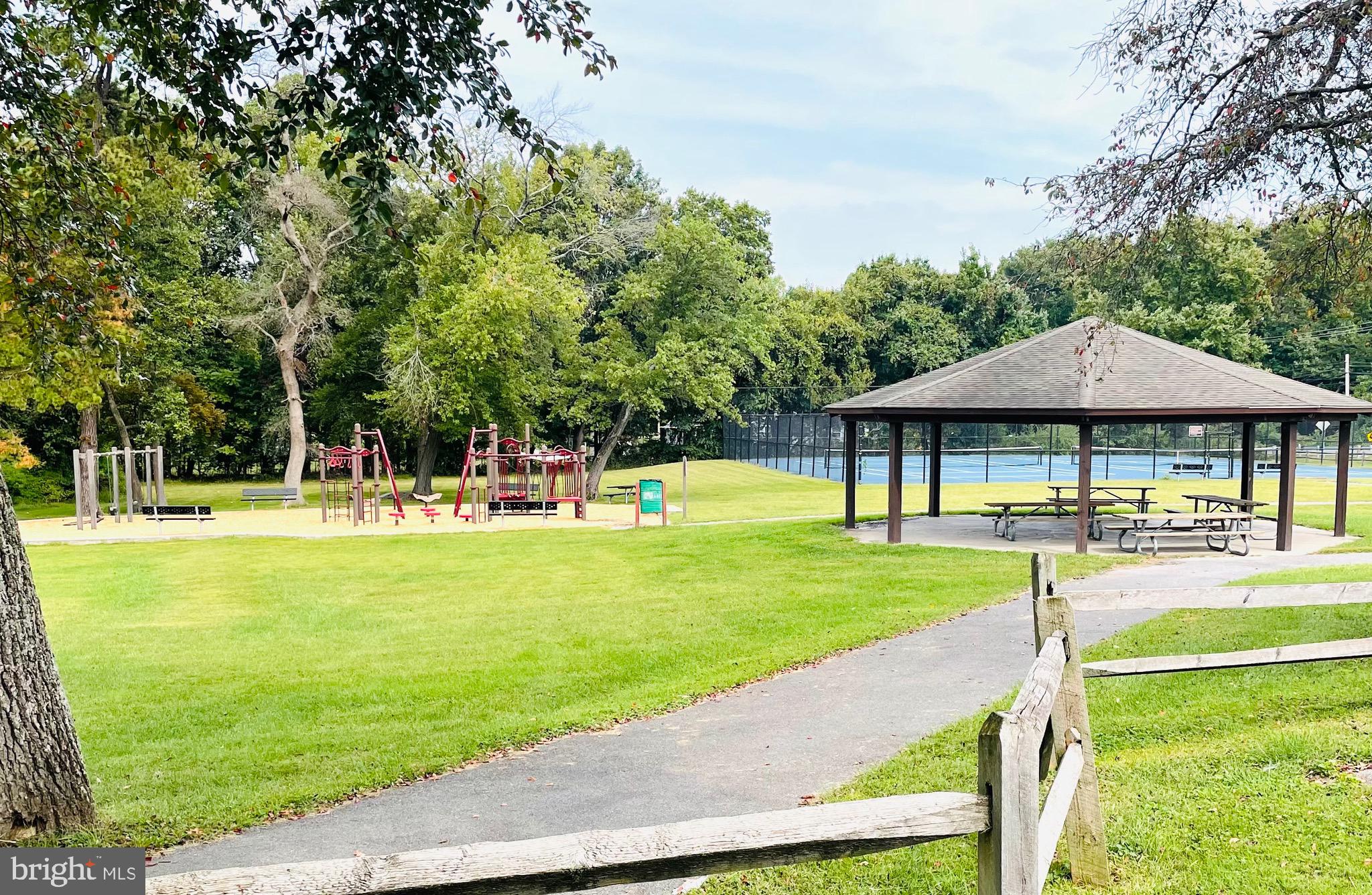 7490 Race Road Hanover, MD 21076 - Photo 19 of 19 a view of a swimming pool with lawn chairs under an umbrella