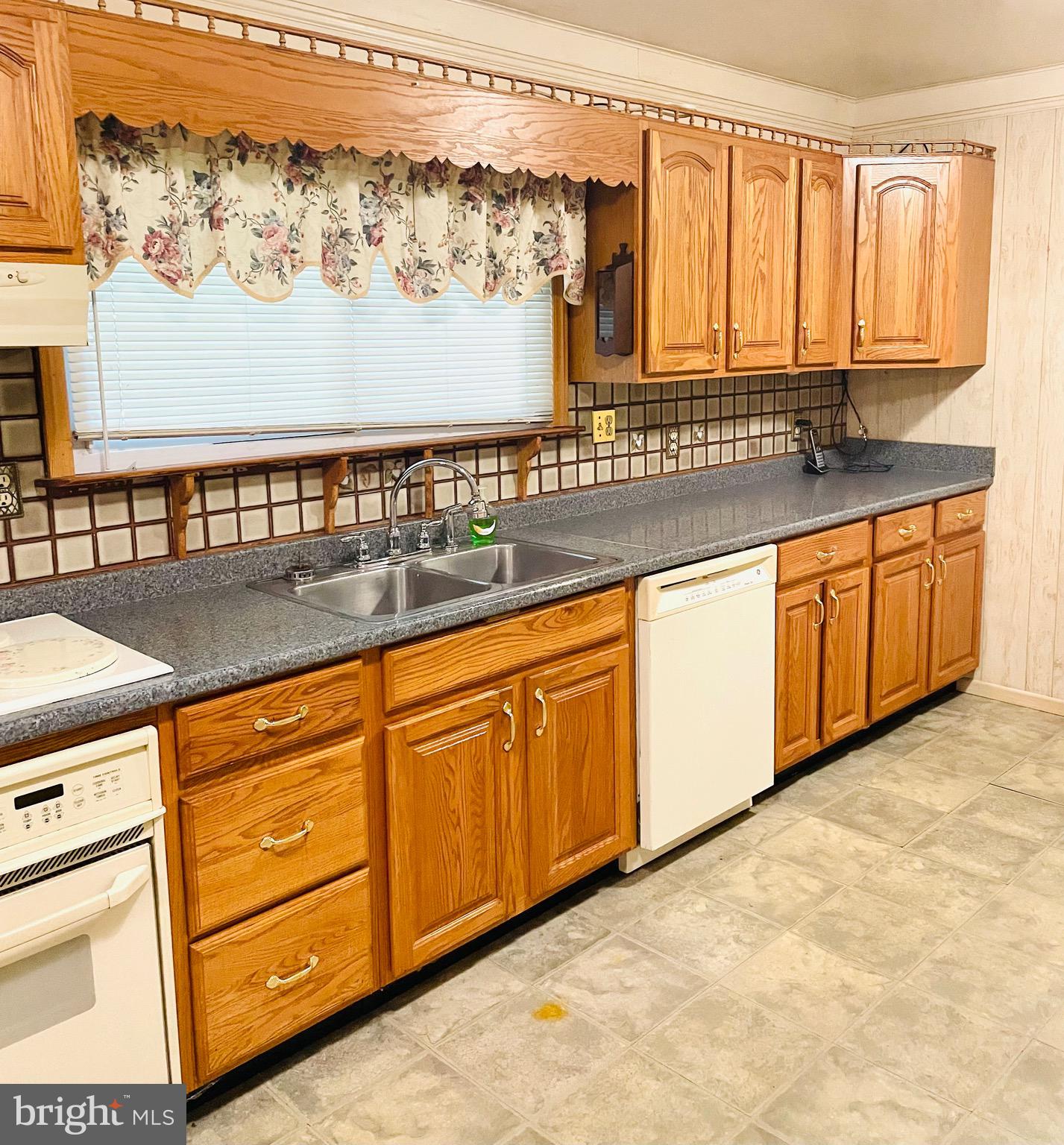 7490 Race Road Hanover, MD 21076 - Photo 6 of 19 a view of a kitchen with granite countertop cabinets and a wooden floor