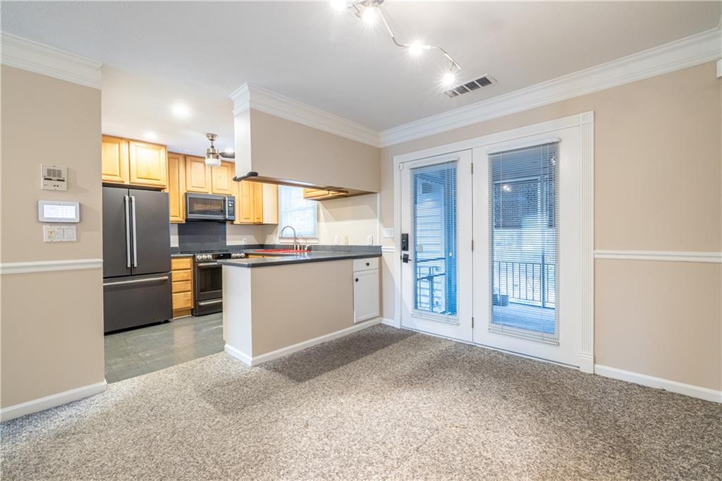 6700 Roswell Road, Unit 1C Sandy Springs, GA 30328 - Photo 11 of 41 a kitchen with stainless steel appliances a refrigerator and a sink