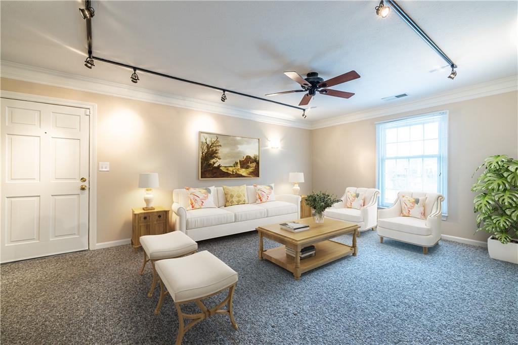 6700 Roswell Road, Unit 1C Sandy Springs, GA 30328 - Photo 13 of 41 a living room with furniture and a large window