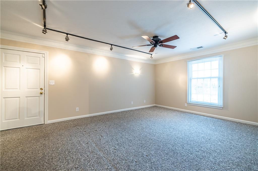6700 Roswell Road, Unit 1C Sandy Springs, GA 30328 - Photo 14 of 41 a view of a livingroom with a ceiling fan and window