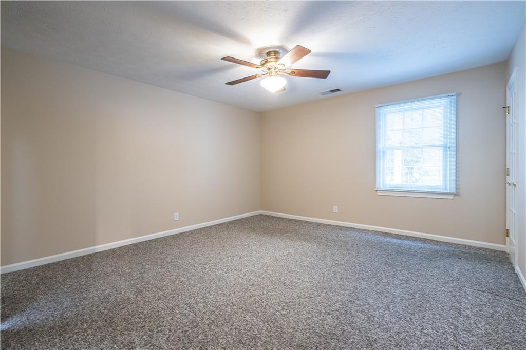 6700 Roswell Road, Unit 1C Sandy Springs, GA 30328 - Photo 18 of 41 an empty room with a window and a fan