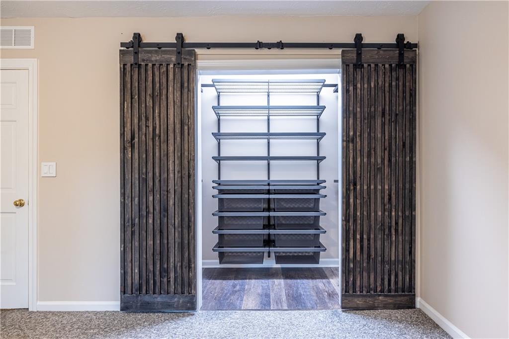 6700 Roswell Road, Unit 1C Sandy Springs, GA 30328 - Photo 20 of 41 a view of walk in closet with clothes and shoes