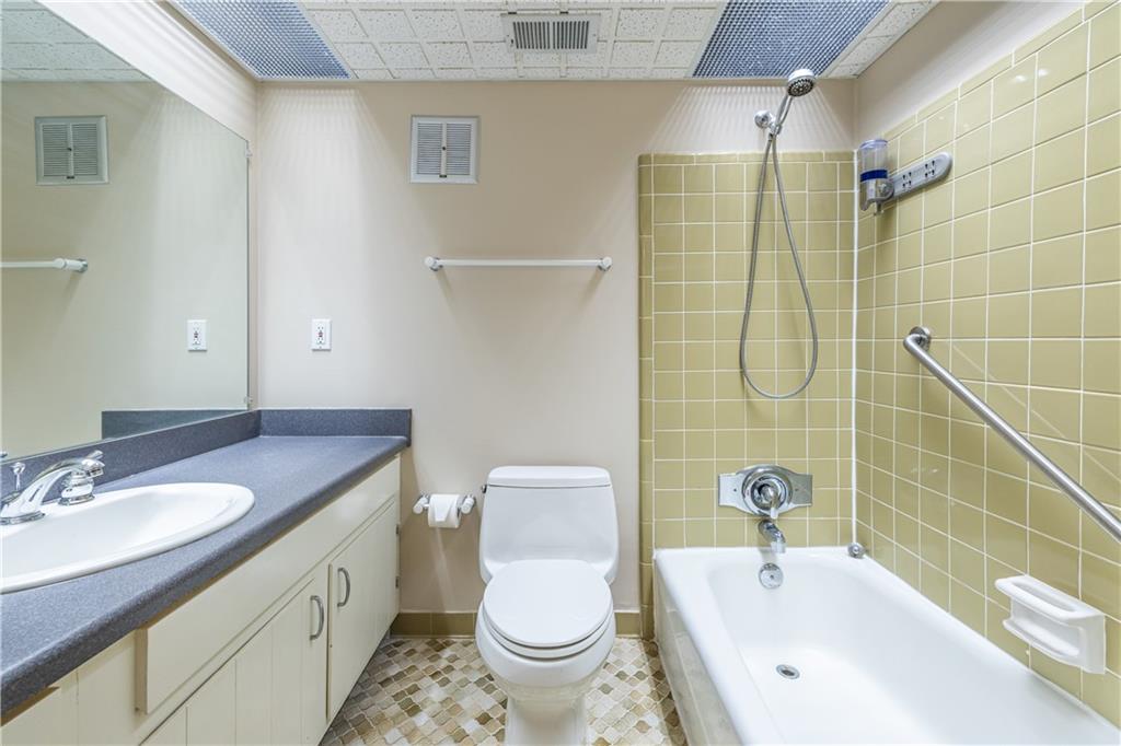 6700 Roswell Road, Unit 1C Sandy Springs, GA 30328 - Photo 24 of 41 a bathroom with a sink a toilet and shower