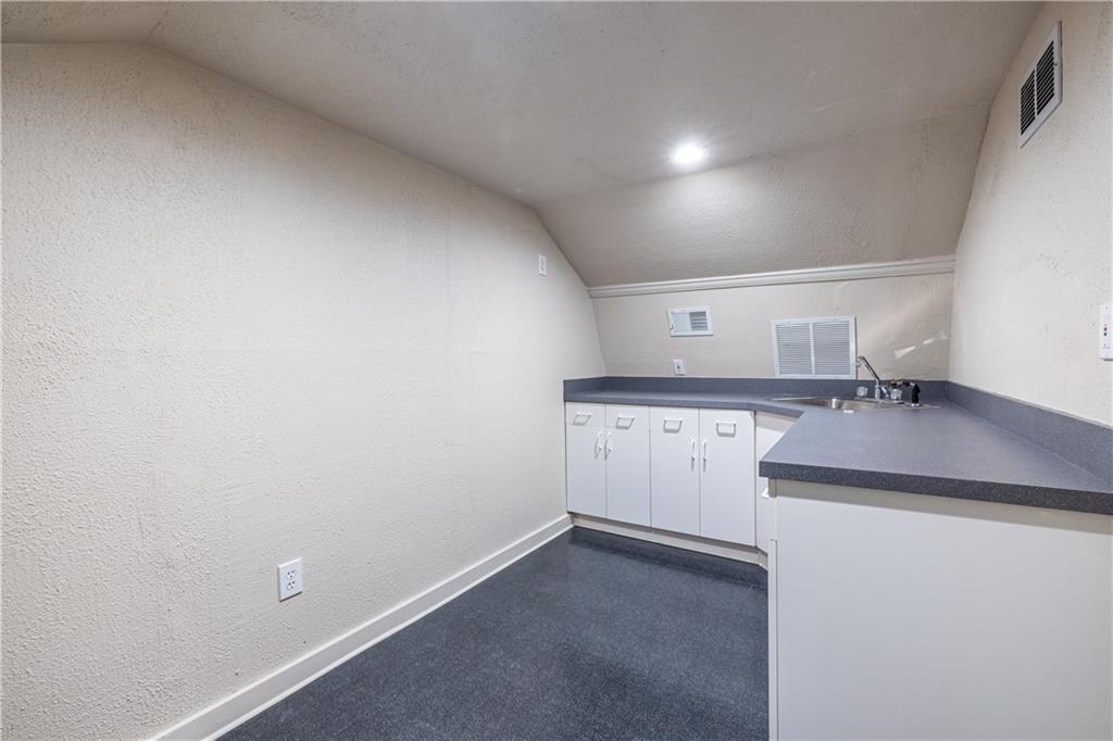 6700 Roswell Road, Unit 1C Sandy Springs, GA 30328 - Photo 30 of 41 a kitchen with a sink and cabinets
