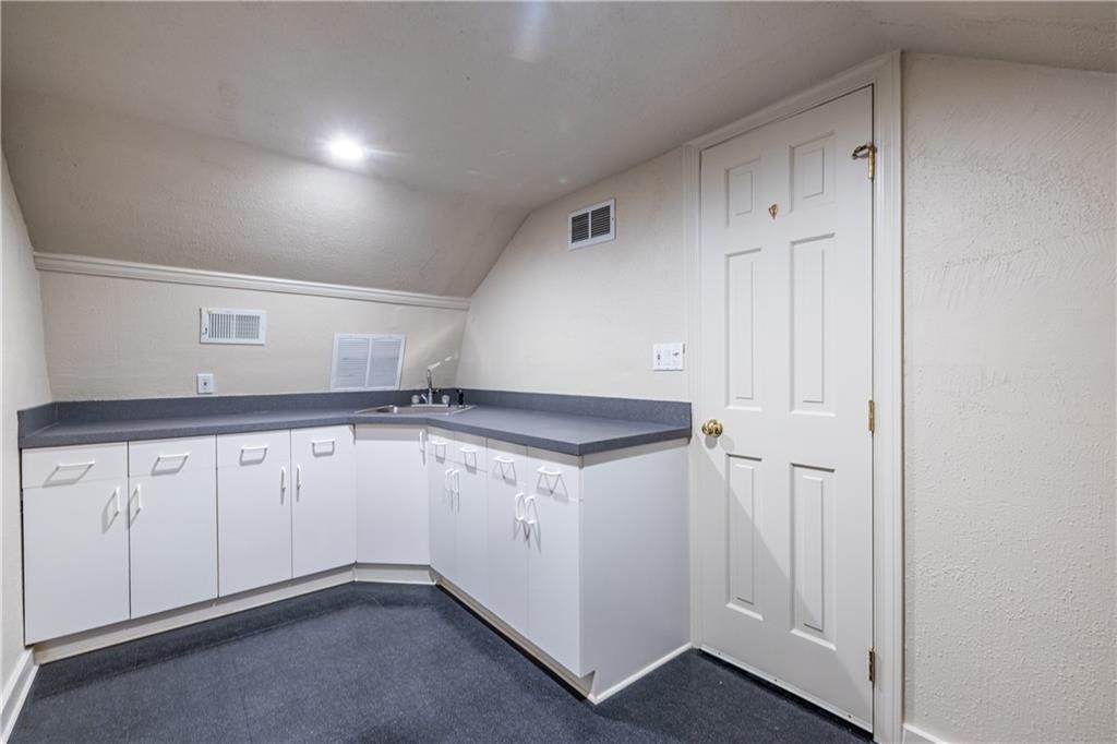 6700 Roswell Road, Unit 1C Sandy Springs, GA 30328 - Photo 31 of 41 a utility room with granite countertop cabinets and a sink