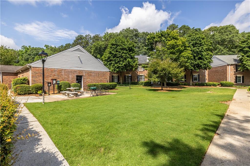 6700 Roswell Road, Unit 1C Sandy Springs, GA 30328 - Photo 39 of 41 a view of a patio with table and chairs and potted plants