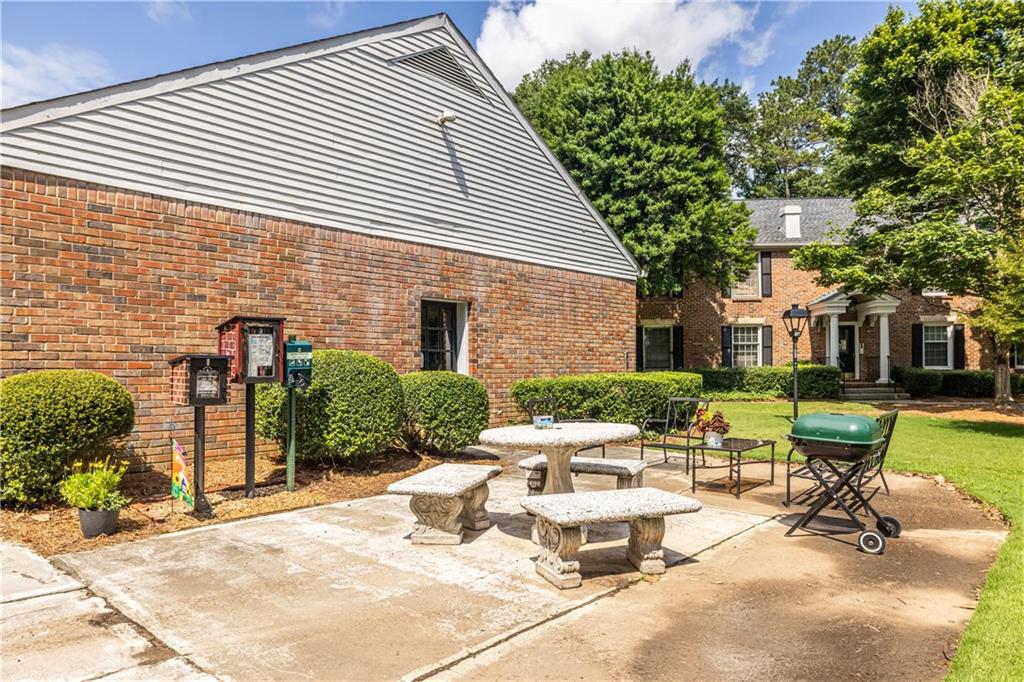 6700 Roswell Road, Unit 1C Sandy Springs, GA 30328 - Photo 40 of 41 a view of a dinning table and chairs in the patio of the house
