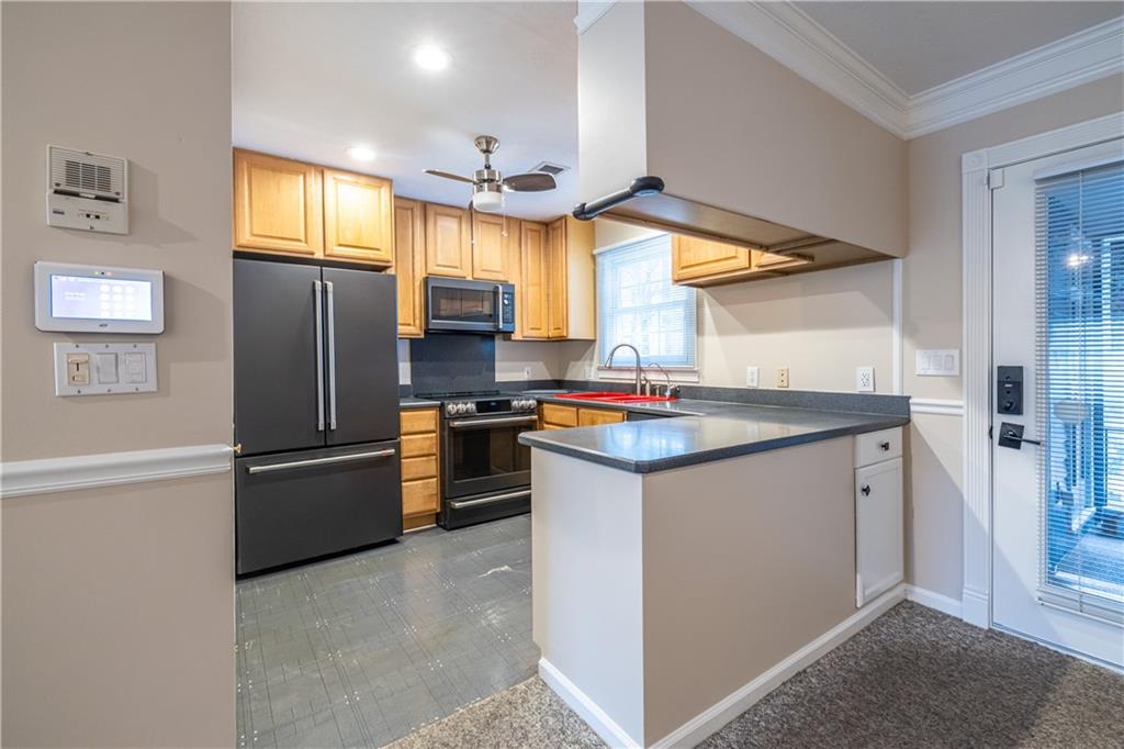 6700 Roswell Road, Unit 1C Sandy Springs, GA 30328 - Photo 5 of 41 a kitchen with stainless steel appliances granite countertop a refrigerator and a sink