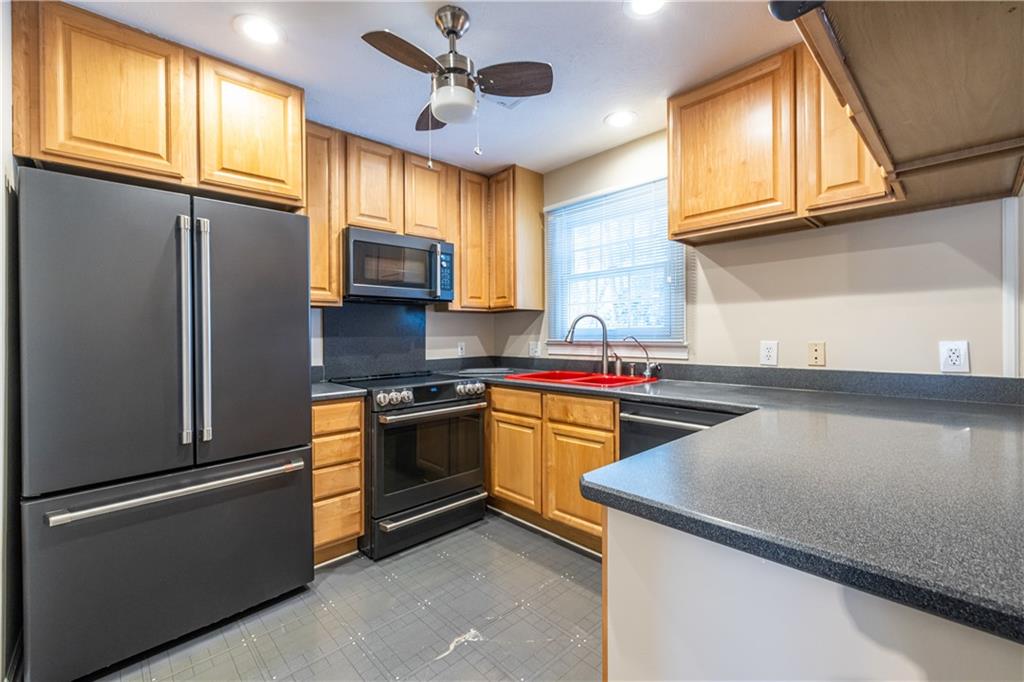 6700 Roswell Road, Unit 1C Sandy Springs, GA 30328 - Photo 6 of 41 a kitchen with stainless steel appliances granite countertop a refrigerator a stove a sink and dishwasher
