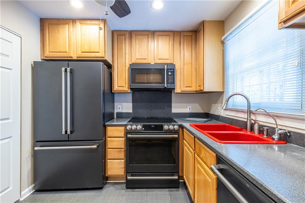 6700 Roswell Road, Unit 1C Sandy Springs, GA 30328 - Photo 7 of 41 a kitchen with granite countertop stainless steel appliances and window