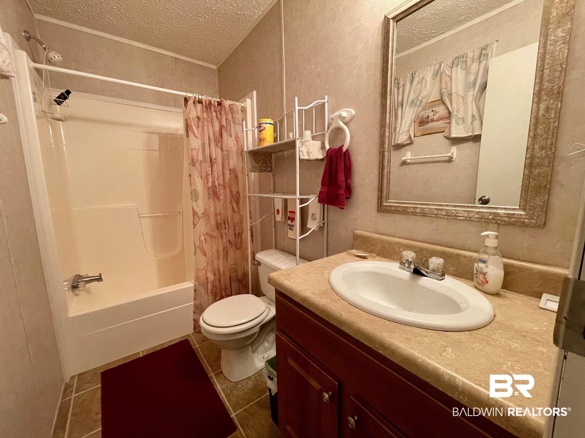 15338 Windbigler Drive Foley, AL 36535 - Photo 20 of 28 Full bathroom featuring tile patterned flooring, a textured ceiling, toilet, shower / bath combination with curtain, and vanity