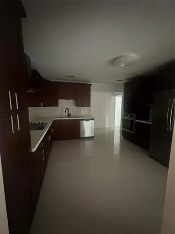 a kitchen with refrigerator and window