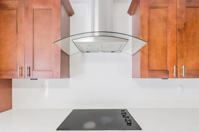 an empty room with windows and ceiling fan